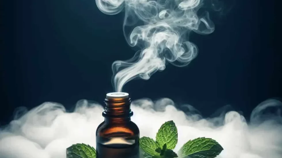 cloudy image of peppermint oil emanating from a bottle